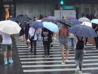 Pedestrians are walking during a rainstorm in Beijing, China, on August 9, 2024. (