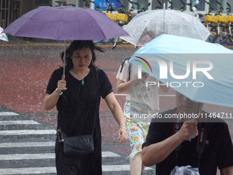 Pedestrians are walking during a rainstorm in Beijing, China, on August 9, 2024. (