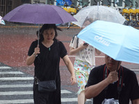 Pedestrians are walking during a rainstorm in Beijing, China, on August 9, 2024. (