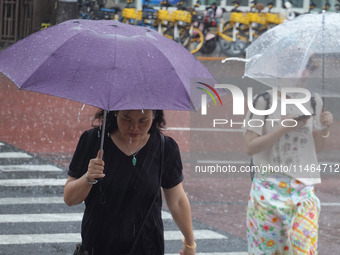 Pedestrians are walking during a rainstorm in Beijing, China, on August 9, 2024. (