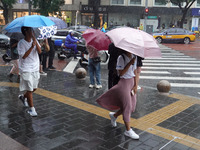 Pedestrians are walking during a rainstorm in Beijing, China, on August 9, 2024. (