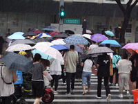 Pedestrians are walking during a rainstorm in Beijing, China, on August 9, 2024. (