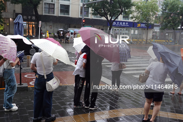 Pedestrians are walking during a rainstorm in Beijing, China, on August 9, 2024. 