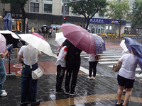 Pedestrians are walking during a rainstorm in Beijing, China, on August 9, 2024. (