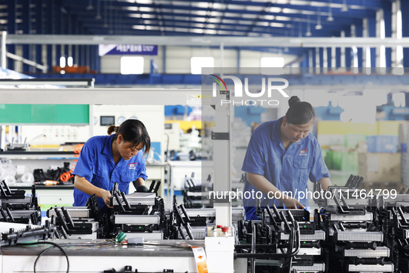 Workers are working at a production workshop of an auto parts company in Suqian, Jiangsu province, China, on August 9, 2024. 