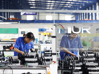 Workers are working at a production workshop of an auto parts company in Suqian, Jiangsu province, China, on August 9, 2024. (