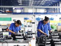 Workers are working at a production workshop of an auto parts company in Suqian, Jiangsu province, China, on August 9, 2024. (