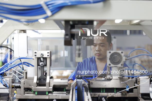 Workers are working at a production workshop of an auto parts company in Suqian, Jiangsu province, China, on August 9, 2024. 