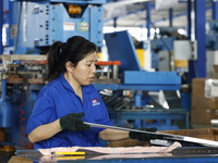 Workers are working at a production workshop of an auto parts company in Suqian, Jiangsu province, China, on August 9, 2024. (