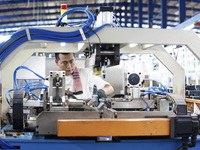 Workers are working at a production workshop of an auto parts company in Suqian, Jiangsu province, China, on August 9, 2024. (