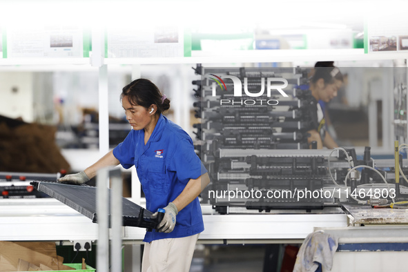 Workers are working at a production workshop of an auto parts company in Suqian, Jiangsu province, China, on August 9, 2024. 