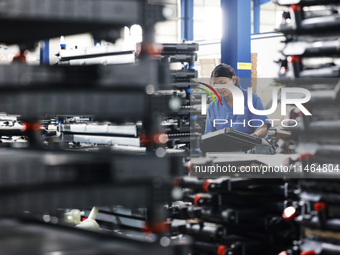 Workers are working at a production workshop of an auto parts company in Suqian, Jiangsu province, China, on August 9, 2024. (