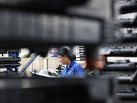 Workers are working at a production workshop of an auto parts company in Suqian, Jiangsu province, China, on August 9, 2024. (