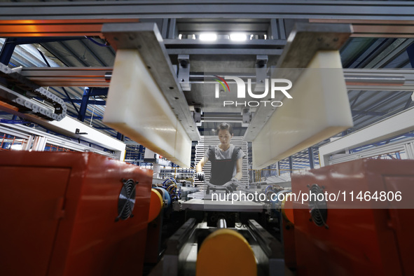 Workers are working at a production workshop of an auto parts company in Suqian, Jiangsu province, China, on August 9, 2024. 