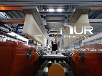 Workers are working at a production workshop of an auto parts company in Suqian, Jiangsu province, China, on August 9, 2024. (