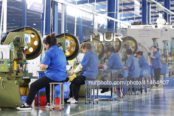 Workers are working at a production workshop of an auto parts company in Suqian, Jiangsu province, China, on August 9, 2024. 