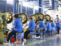 Workers are working at a production workshop of an auto parts company in Suqian, Jiangsu province, China, on August 9, 2024. (