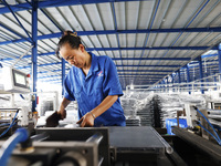 Workers are working at a production workshop of an auto parts company in Suqian, Jiangsu province, China, on August 9, 2024. (