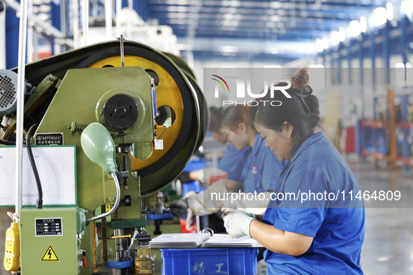 Workers are working at a production workshop of an auto parts company in Suqian, Jiangsu province, China, on August 9, 2024. 