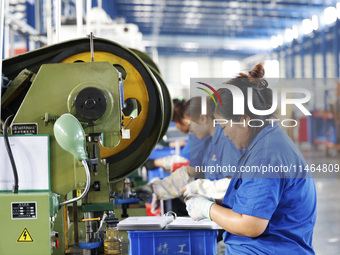 Workers are working at a production workshop of an auto parts company in Suqian, Jiangsu province, China, on August 9, 2024. (