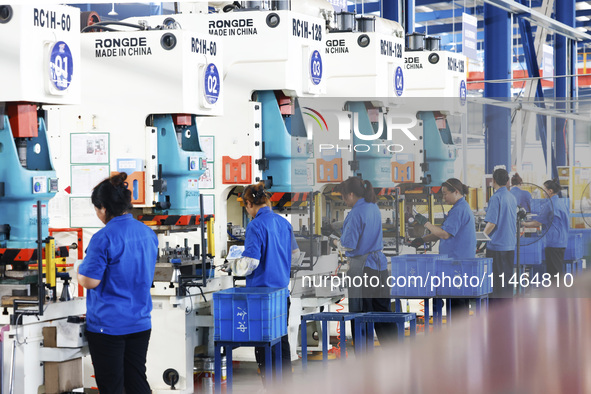 Workers are working at a production workshop of an auto parts company in Suqian, Jiangsu province, China, on August 9, 2024. 