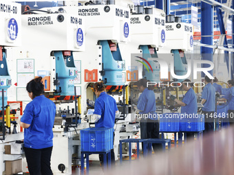 Workers are working at a production workshop of an auto parts company in Suqian, Jiangsu province, China, on August 9, 2024. (