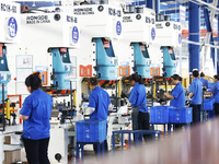 Workers are working at a production workshop of an auto parts company in Suqian, Jiangsu province, China, on August 9, 2024. (