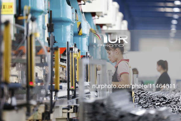 Workers are working at a production workshop of an auto parts company in Suqian, Jiangsu province, China, on August 9, 2024. 