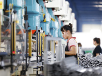 Workers are working at a production workshop of an auto parts company in Suqian, Jiangsu province, China, on August 9, 2024. (