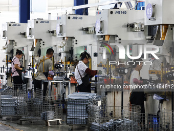 Workers are working at a production workshop of an auto parts company in Suqian, Jiangsu province, China, on August 9, 2024. (