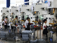 Workers are working at a production workshop of an auto parts company in Suqian, Jiangsu province, China, on August 9, 2024. (