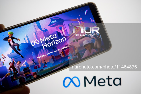 The Meta Horizon Worlds is being displayed on a smartphone screen, and the Meta logo is in the background in Chania, Greece, on August 9, 20...