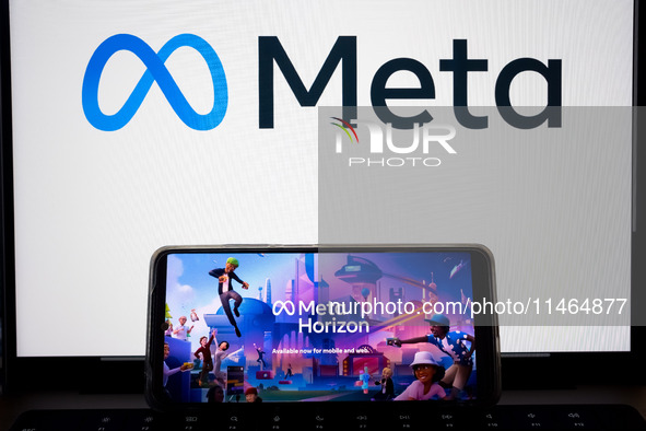 The Meta Horizon Worlds is being displayed on a smartphone screen, and the Meta logo is in the background in Chania, Greece, on August 9, 20...