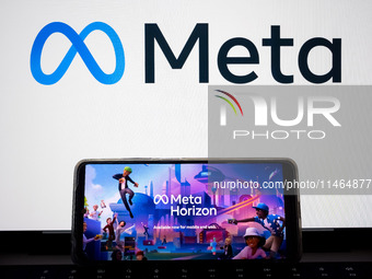 The Meta Horizon Worlds is being displayed on a smartphone screen, and the Meta logo is in the background in Chania, Greece, on August 9, 20...