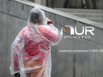 Pedestrians are protecting themselves from the rain in the central region of Sao Paulo, Brazil, on Friday, August 9. (