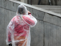 Pedestrians are protecting themselves from the rain in the central region of Sao Paulo, Brazil, on Friday, August 9. (