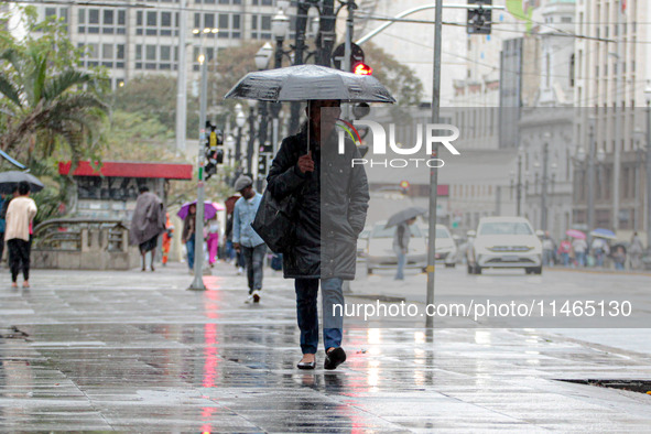 Pedestrians are protecting themselves from the rain in the central region of Sao Paulo, Brazil, on Friday, August 9. 