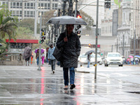 Pedestrians are protecting themselves from the rain in the central region of Sao Paulo, Brazil, on Friday, August 9. (