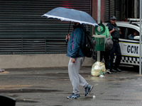 Pedestrians are protecting themselves from the rain in the central region of Sao Paulo, Brazil, on Friday, August 9. (