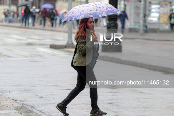 Pedestrians are protecting themselves from the rain in the central region of Sao Paulo, Brazil, on Friday, August 9. 