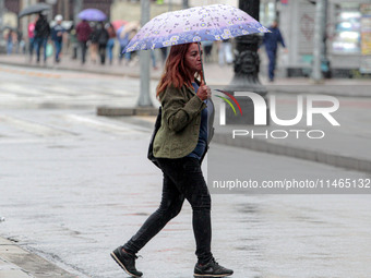 Pedestrians are protecting themselves from the rain in the central region of Sao Paulo, Brazil, on Friday, August 9. (