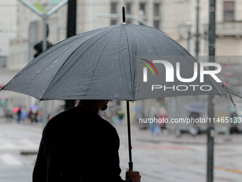 Pedestrians are protecting themselves from the rain in the central region of Sao Paulo, Brazil, on Friday, August 9. (