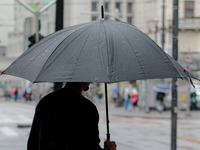 Pedestrians are protecting themselves from the rain in the central region of Sao Paulo, Brazil, on Friday, August 9. (