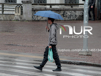 Pedestrians are protecting themselves from the rain in the central region of Sao Paulo, Brazil, on Friday, August 9. (