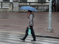 Pedestrians are protecting themselves from the rain in the central region of Sao Paulo, Brazil, on Friday, August 9. (