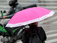 Pedestrians are protecting themselves from the rain in the central region of Sao Paulo, Brazil, on Friday, August 9. (