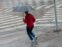 Pedestrians are protecting themselves from the rain in the central region of Sao Paulo, Brazil, on Friday, August 9. (