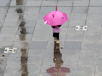 Pedestrians are protecting themselves from the rain in the central region of Sao Paulo, Brazil, on Friday, August 9. (