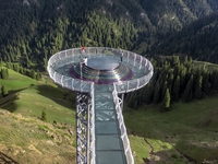 Tourists are experiencing a glass walkway at Pingding Mountain Scenic area in Mulei Kazak Autonomous county, Changji Hui Autonomous prefectu...