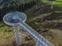 Tourists are experiencing a glass walkway at Pingding Mountain Scenic area in Mulei Kazak Autonomous county, Changji Hui Autonomous prefectu...